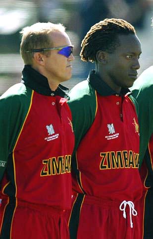 Andy Flower and Henry Olonga stand during the playing of the national anthem at Buffalo Park in East London