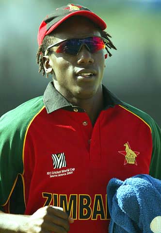 Henry Olonga, playing 12th man, leaves the pitch after a break in the match against Sri Lanka at Buffalo Park in East London