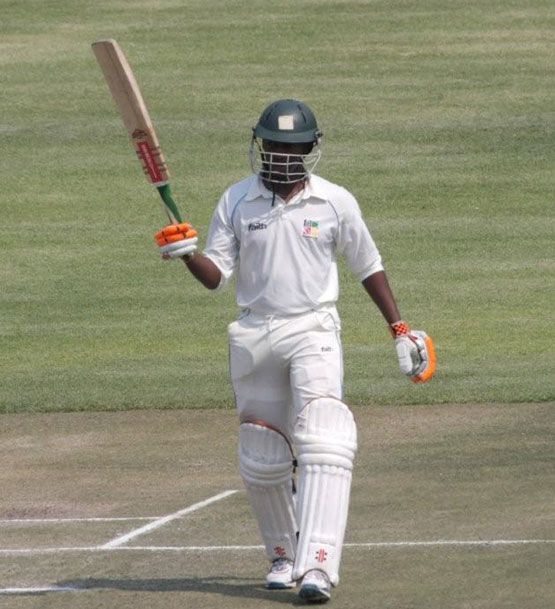 Keith Dabengwa acknowledges the cheers after his century