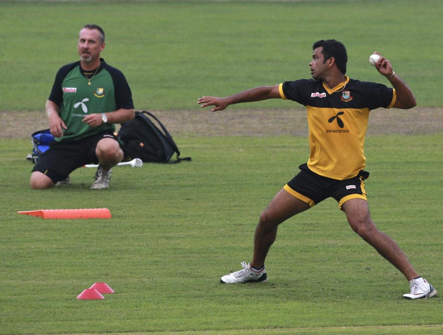 Abdur Razzak is watched by fielding coach Julien Fountain at a training session