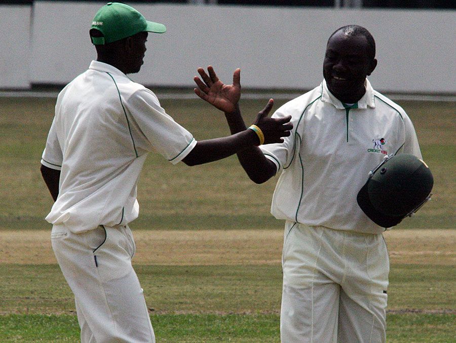 Steve Tikolo congratulates James Ngoche on his five-wicket haul