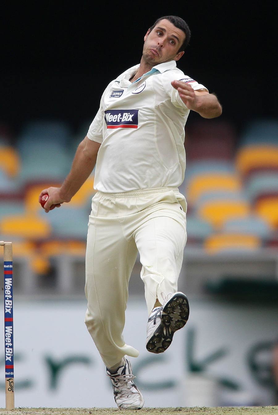 Mark Cameron runs in to bowl