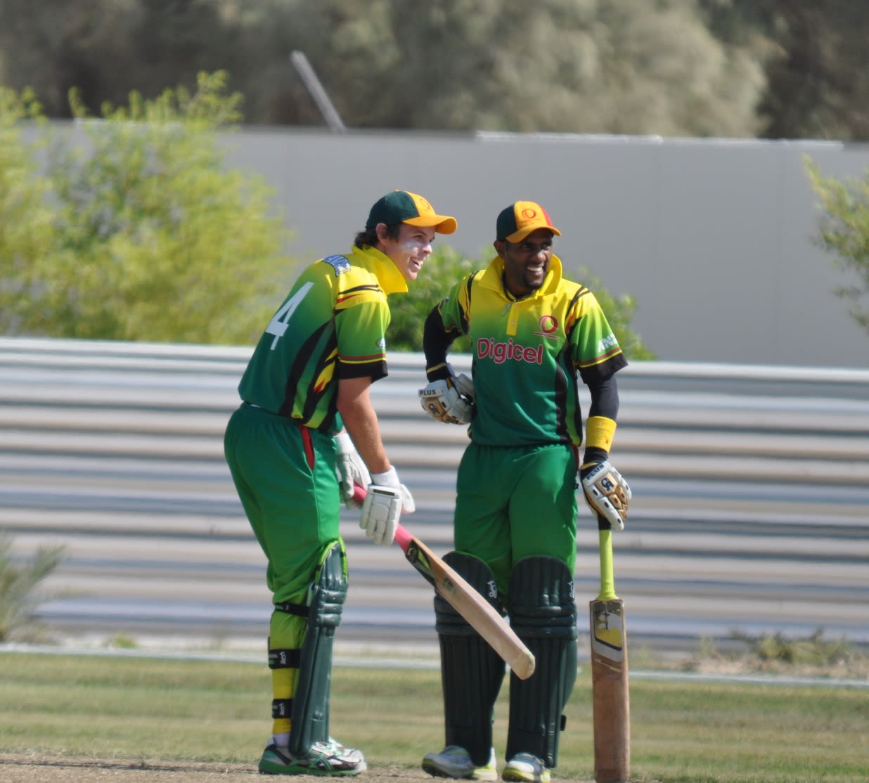 Captain Andrew Mansale (right) shares a joke with Jonathon Dunn after hitting another six
