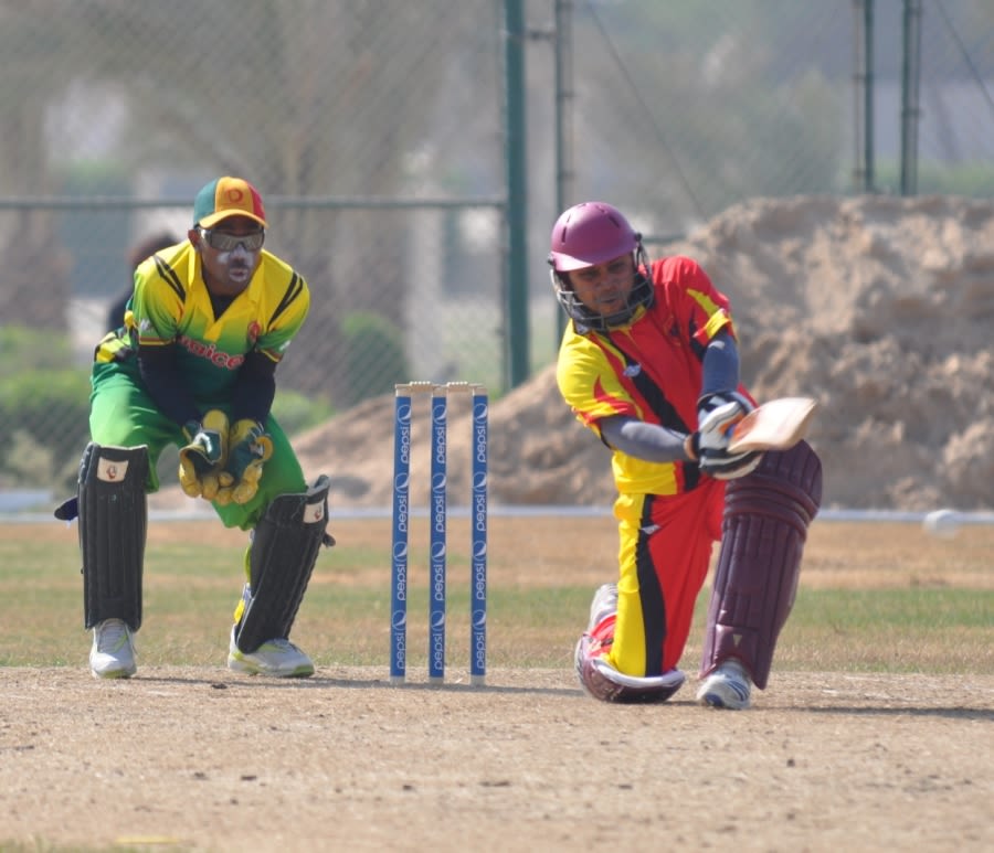 Srinivas Satyanarayana sweeps while Trevor Langa looks on