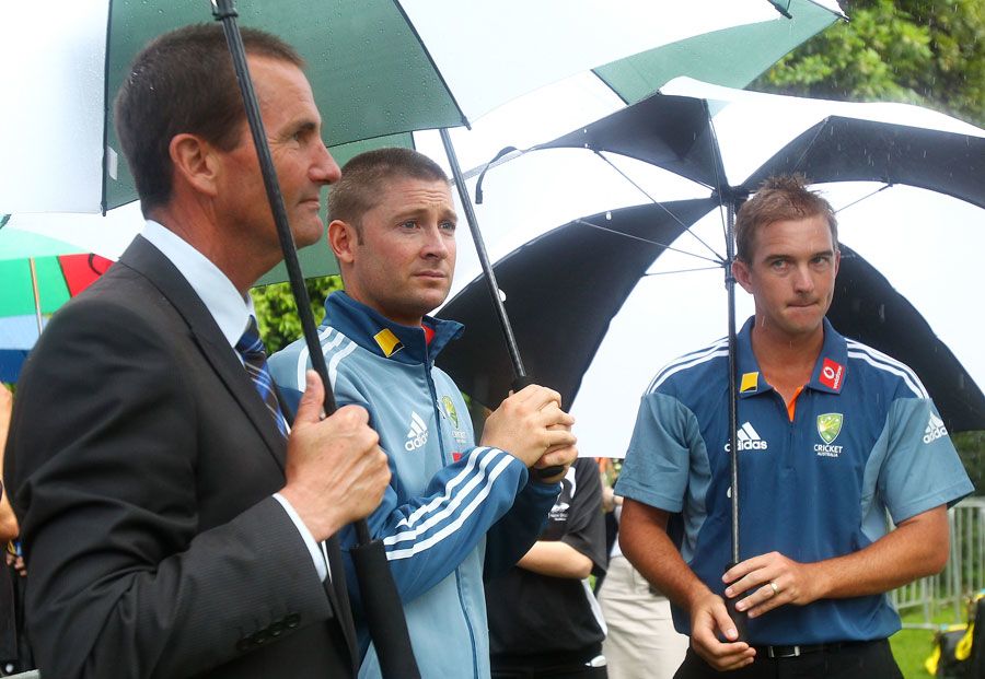 Andrew Hilditch, Michael Clarke and Nathan Hauritz escape the rain at the announcement of Australia's Ashes squad