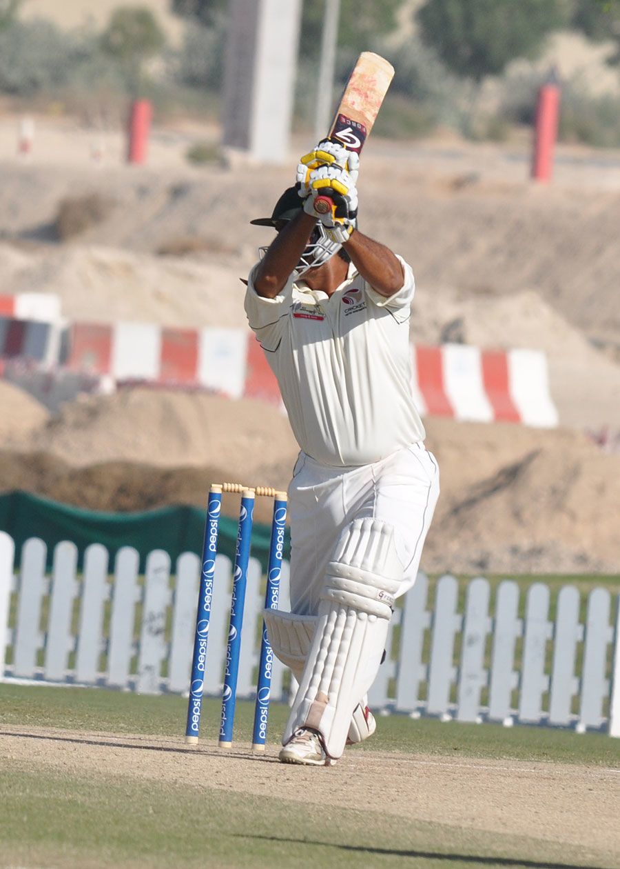 Saqib Ali drives during his hundred against Namibia