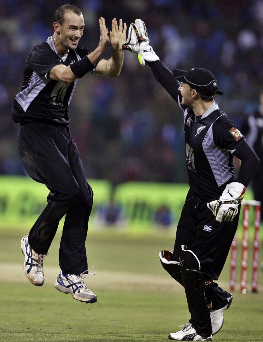 Andy McKay and Brendon McCullum celebrate the wicket of Virat Kohli