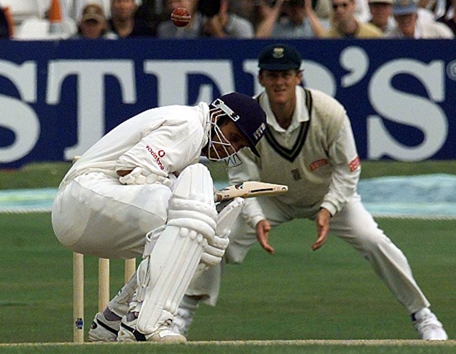 Mark Butcher ducks a short ball as Brian McMillan looks on from the slips