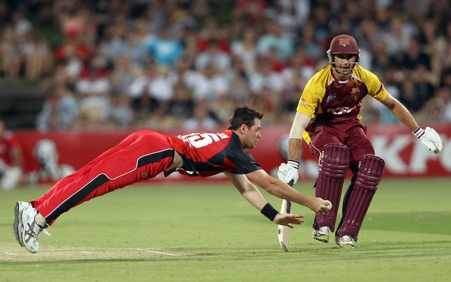 Daniel Christian dives to field one off his own bowling