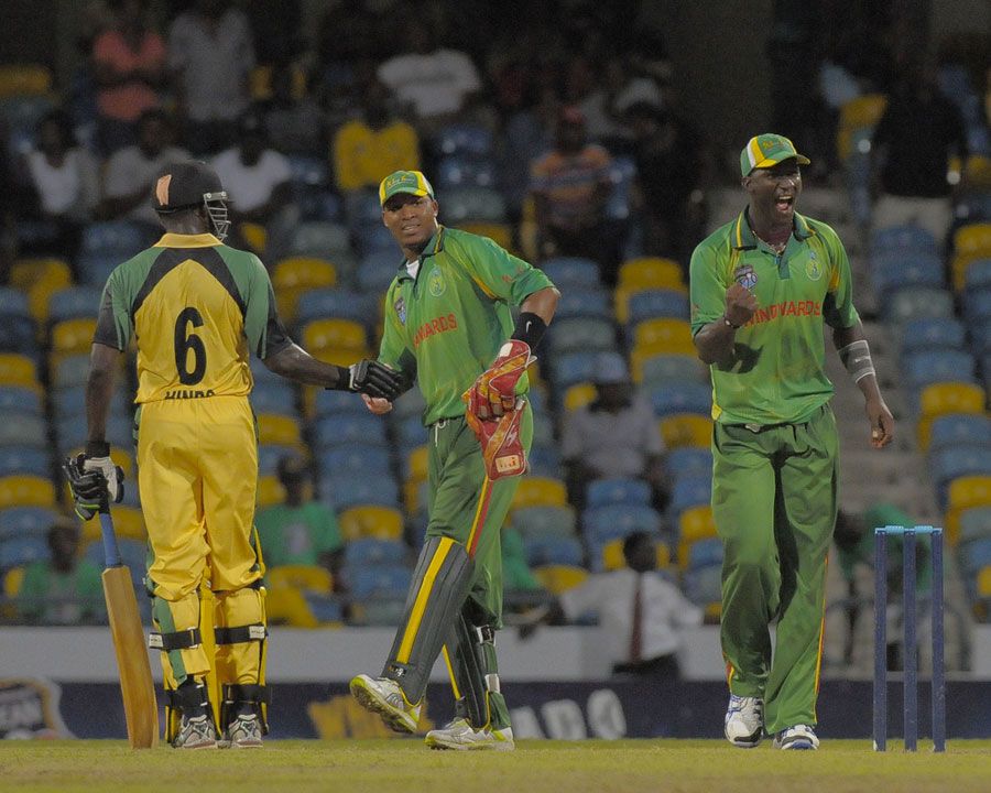 Captain Darren Sammy and Lyndon James celebrate Windwards' win