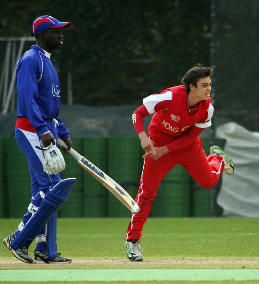Mark Chapman bowls as Lennox Cush looks on