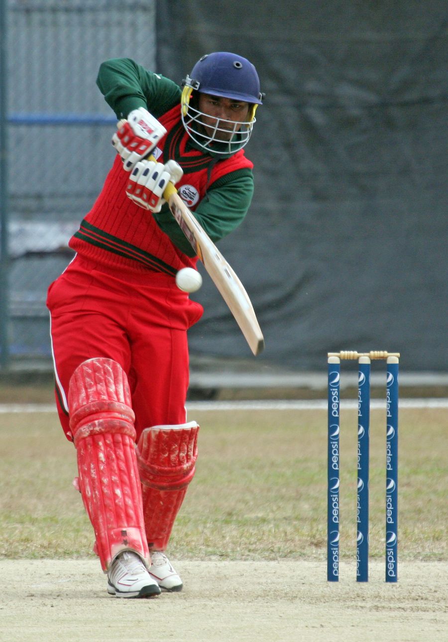 Oman captain Hemal Mehta plays a shot during his century