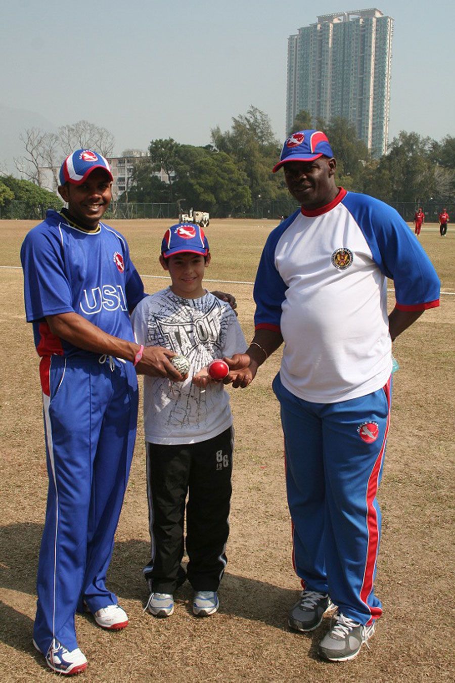 Steve Massiah and Clayton Lambert present a signed ball to young Ryan Schimpf
