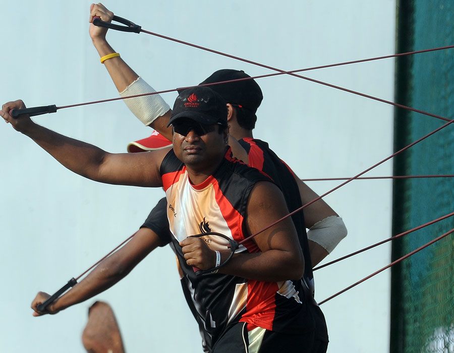 Canada's Balaji Rao stretches with team-mates during practice