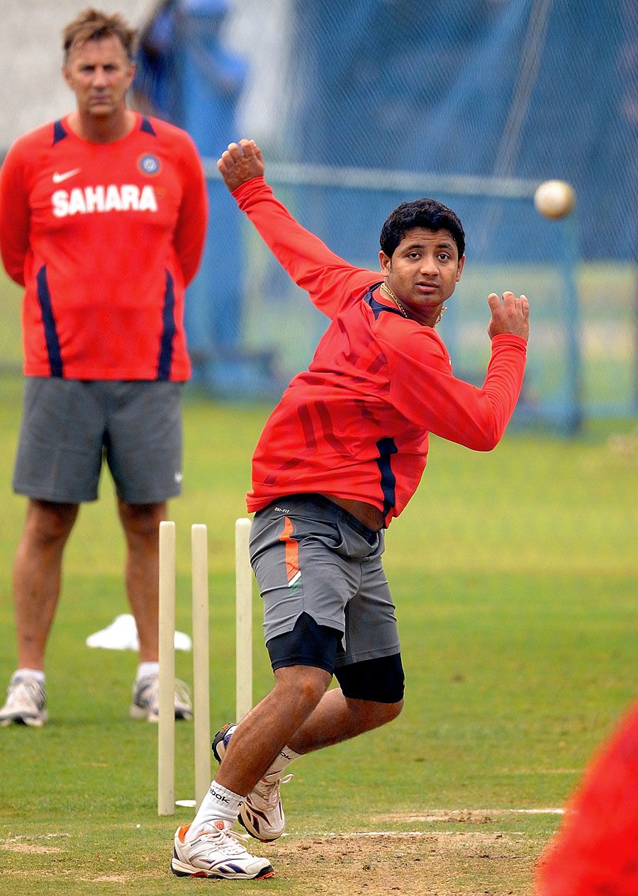 Piyush Chawla lets it rip at the nets as Eric Simons watches on