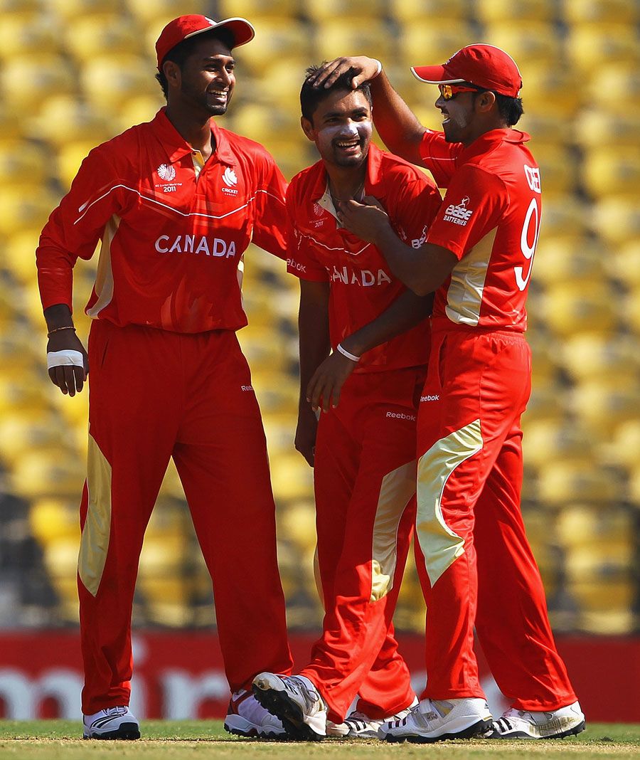 Harvir Baidwan is congratulated by his team-mates after dismissing Charles Coventry