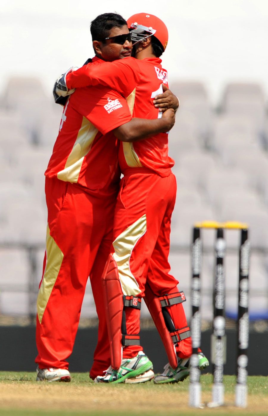 Balaji Rao and Ashish Bagai celebrate the wicket of Tatenda Taibu