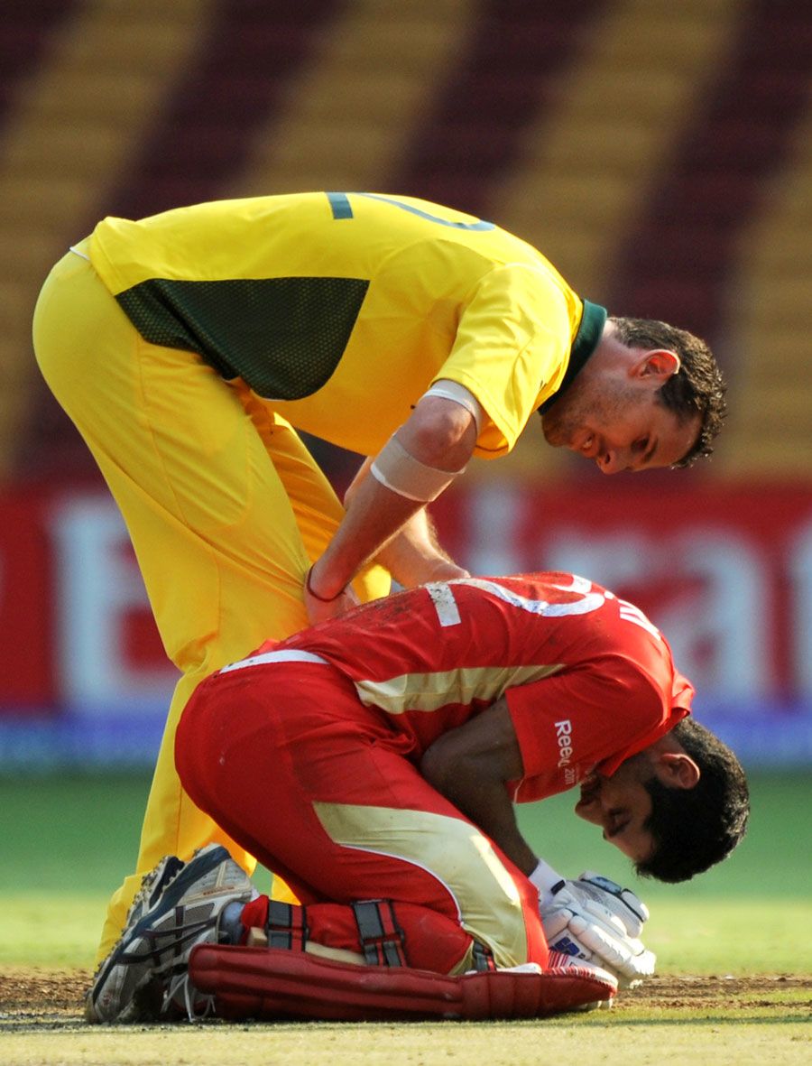 Shaun Tait checks on Zubin Surkari after he was hit by a short ball