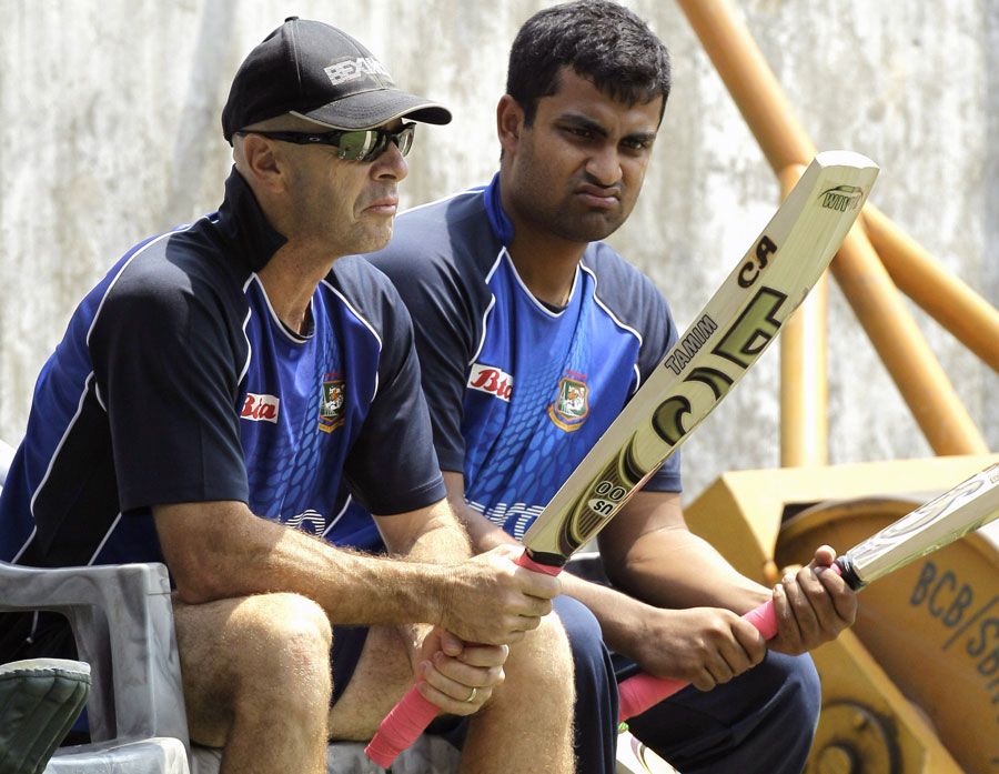 Coach Jamie Siddons and Tamim Iqbal inspect bats during a training session