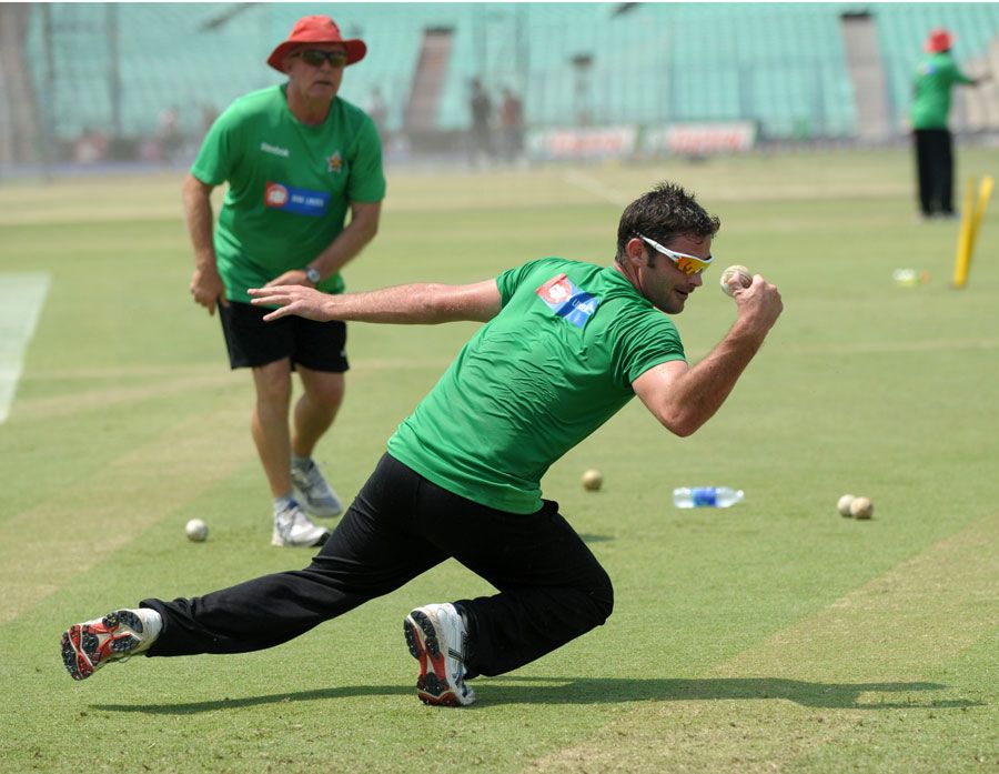 Greg Lamb is put through the paces during fielding practice