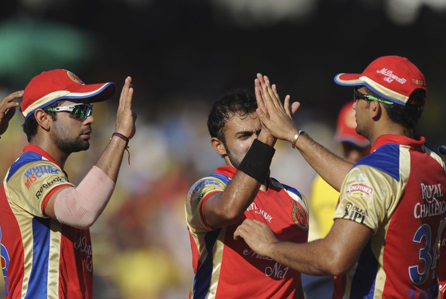 Ryan Ninan is congratulated by team-mates after dismissing M Vijay