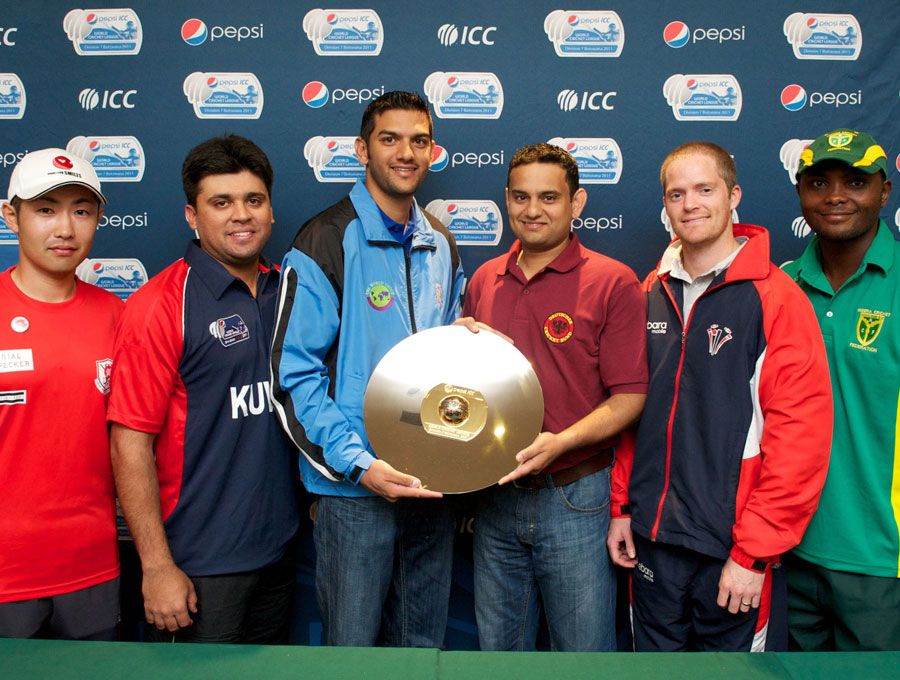The captains of the six participating teams with the World Cricket League Division 7 trophy