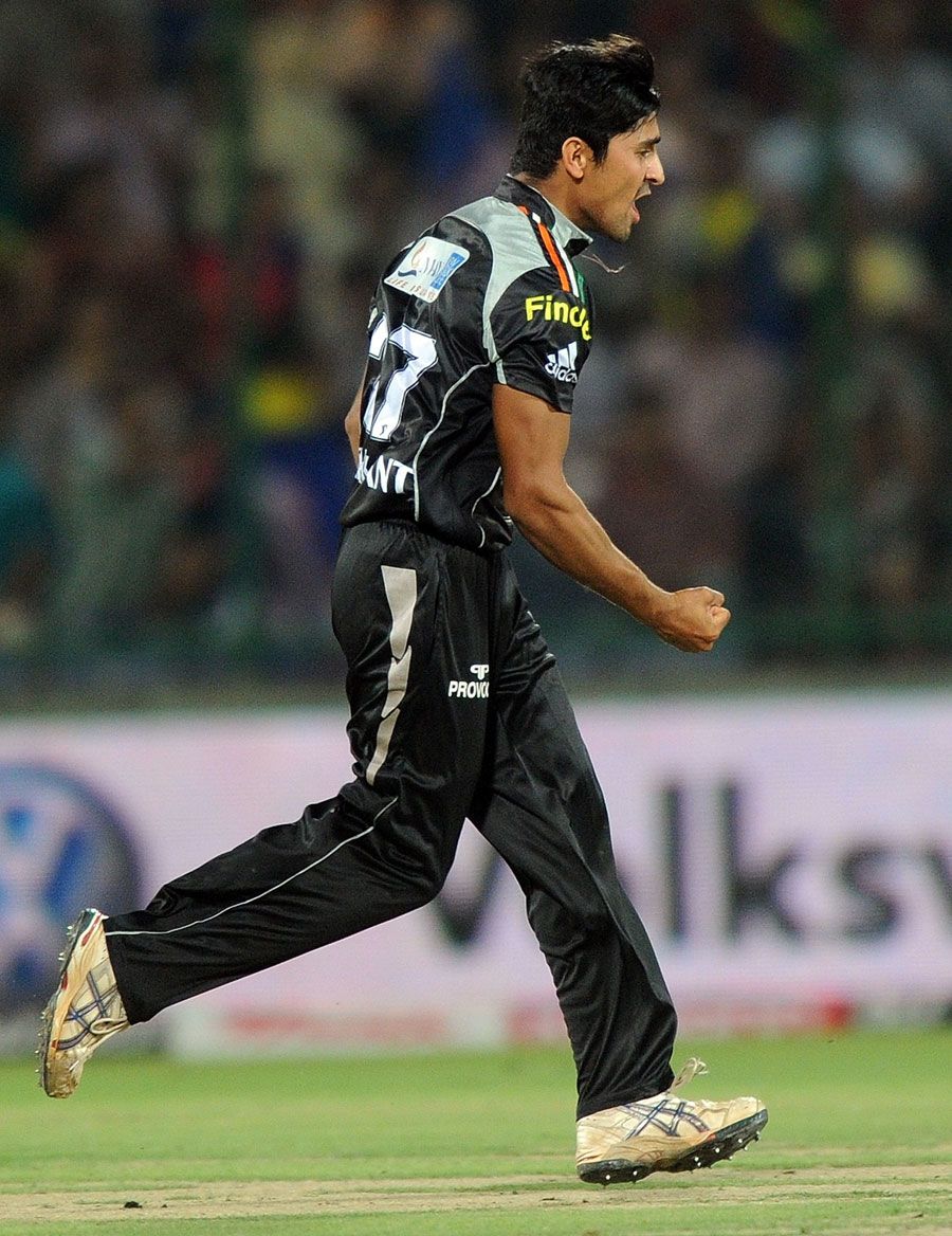 Shrikant Mundhe celebrates the wicket of Naman Ojha