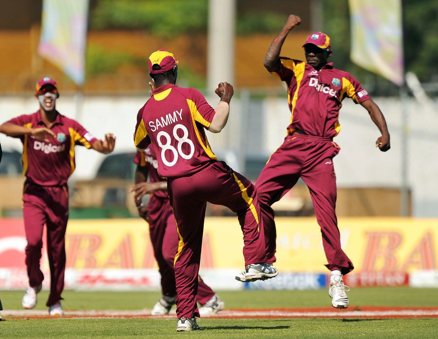 Anthony Martin celebrates taking a catch to dismiss Parthiv Patel