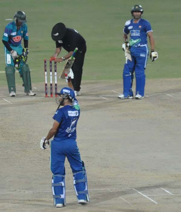 Rameez Raja salutes the crowd on his half-century
