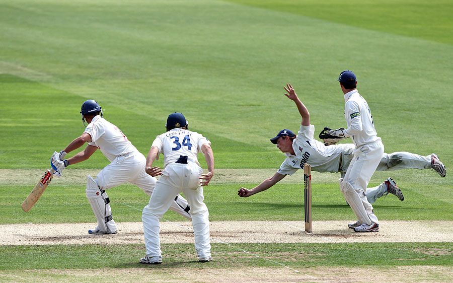 Tom Westley holds a sharp catch to remove Dean Cosker