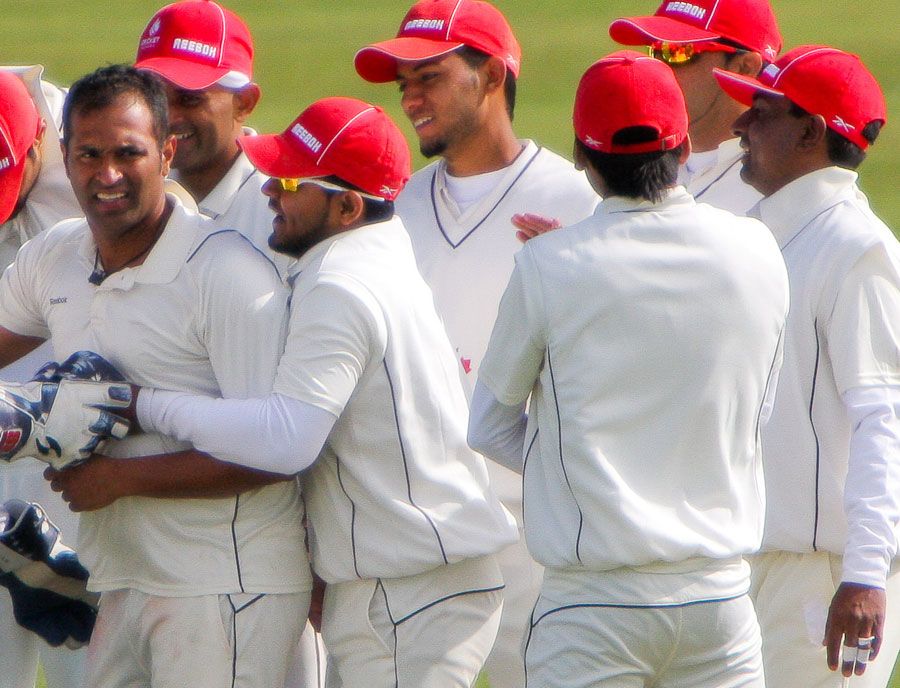 Khurram Chohan is congratulated by his team-mates after dismissing Andrew White