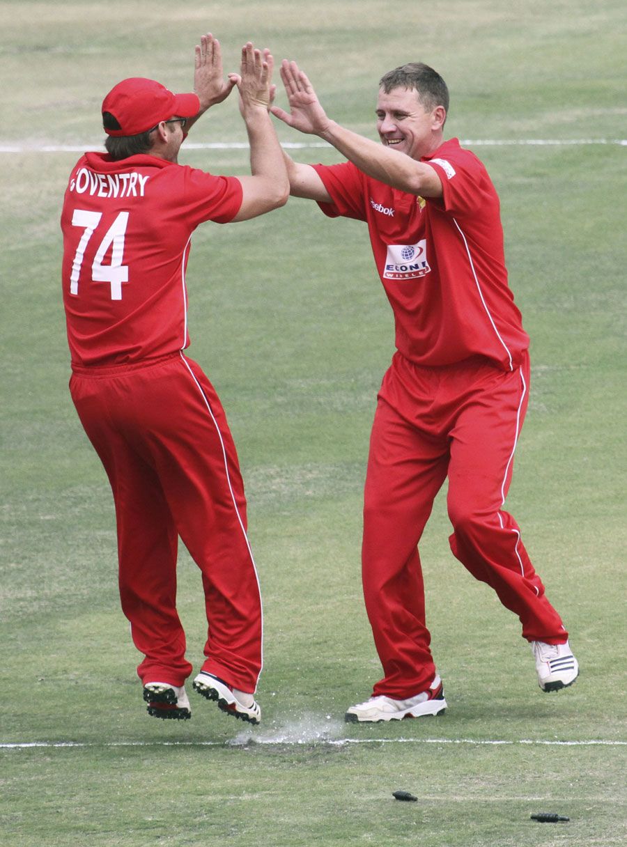 Charles Coventry gets a high five after running out Asad Shafiq