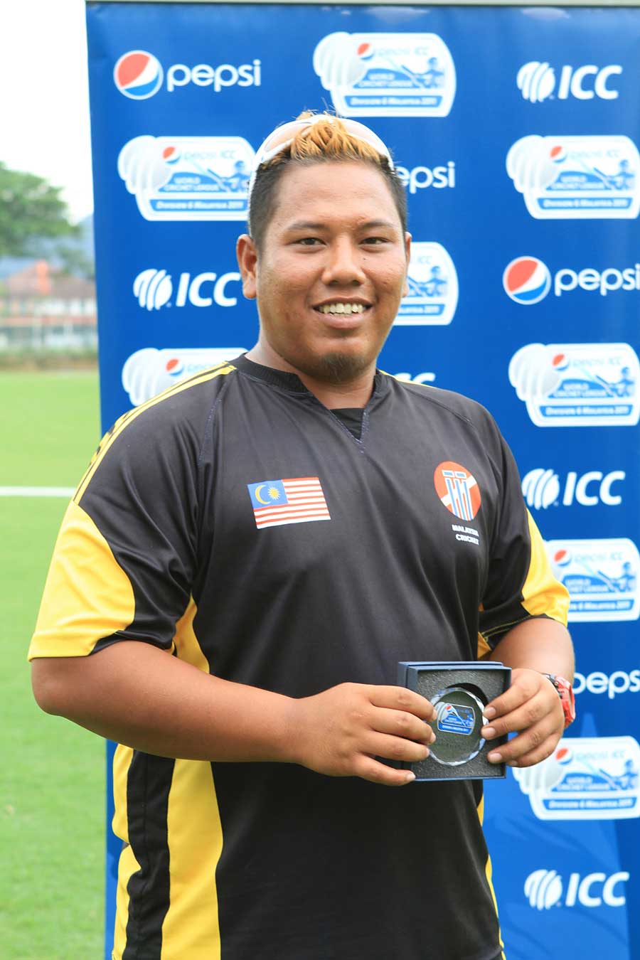 Malaysia's Eszrafiq Aziz with his Man-of-the-Match award after taking 5 for 36