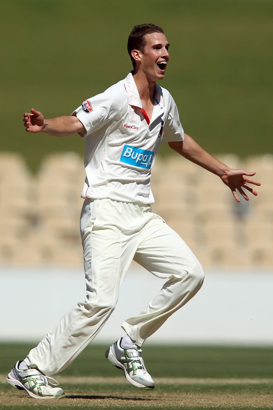 Peter George celebrates the wicket of Phillip Hughes