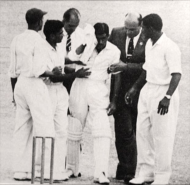 Nari Contractor is led off after being struck by Charlie Griffith