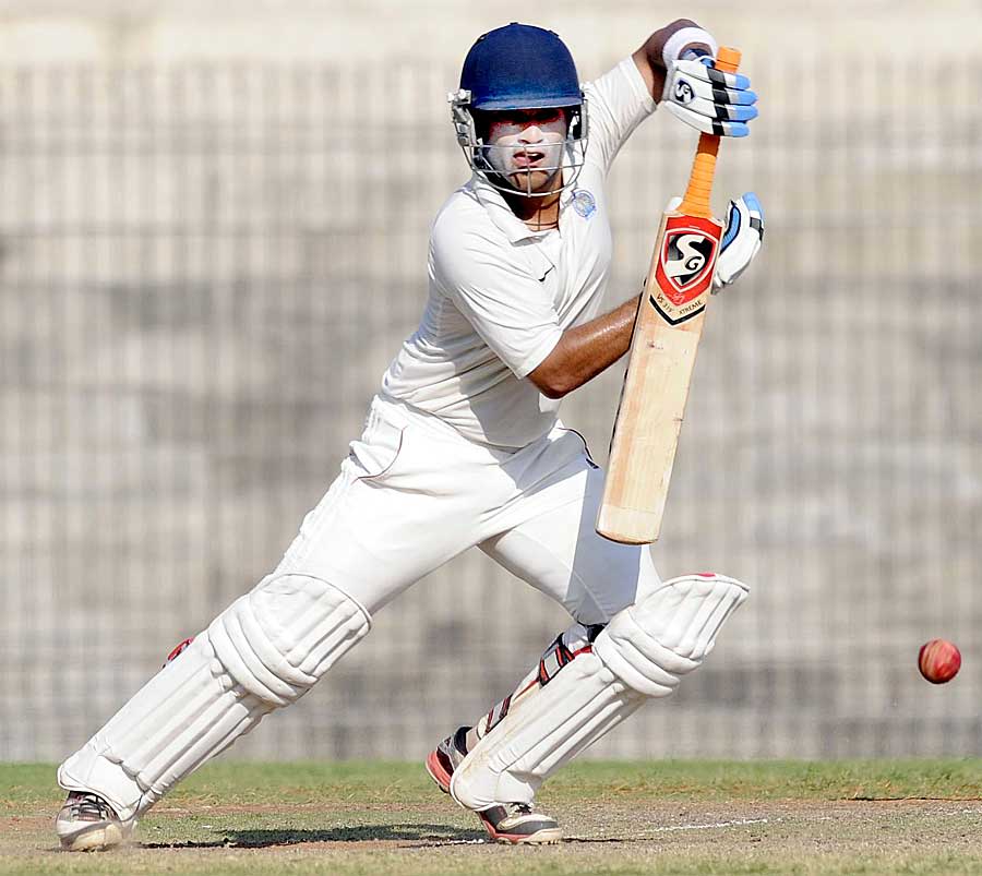 Robin Bist punches one during his century