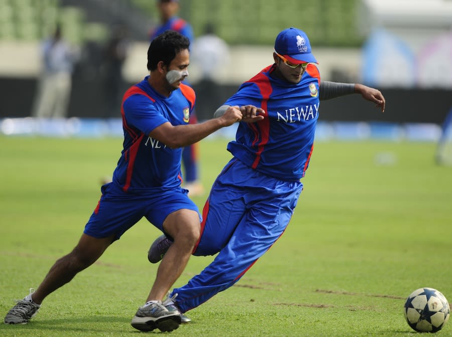 Shakib Al Hasan and Nazimuddin play football during a training session