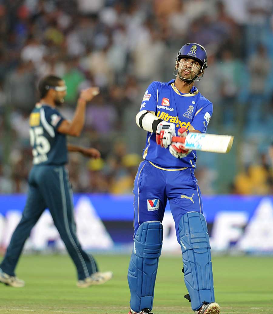 Ashok Menaria walks back after being dismissed