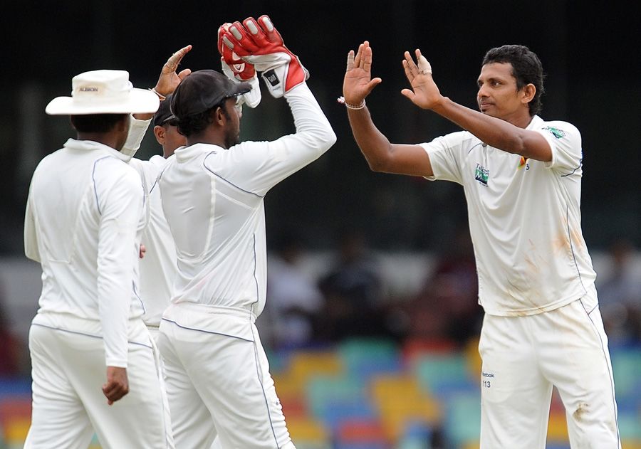 Suraj Randiv celebrates with team-mates after dismissing Azhar Ali