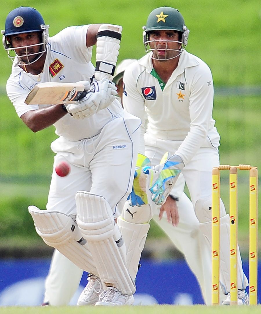 Makeshift keeper Taufeeq Umar looks on as Prasanna Jayawardene bats