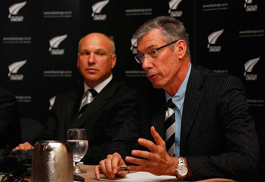 New Zealand Cricket chief executive David White looks on as John Buchanan speaks to the press