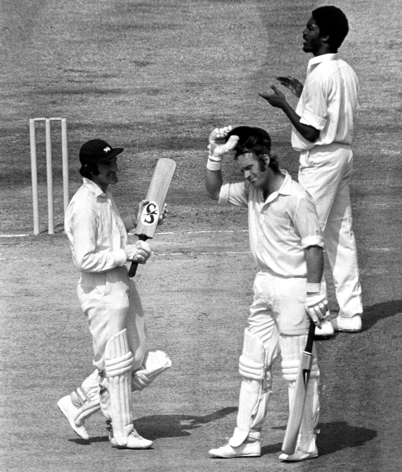 Dennis Amiss is congratulated for his double-century by team-mate Alan Knott and bowler Michael Holding