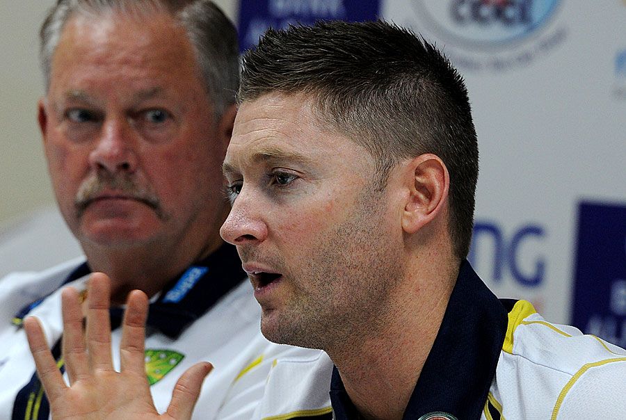Michael Clarke speaks to the media as Steve Rixon looks on