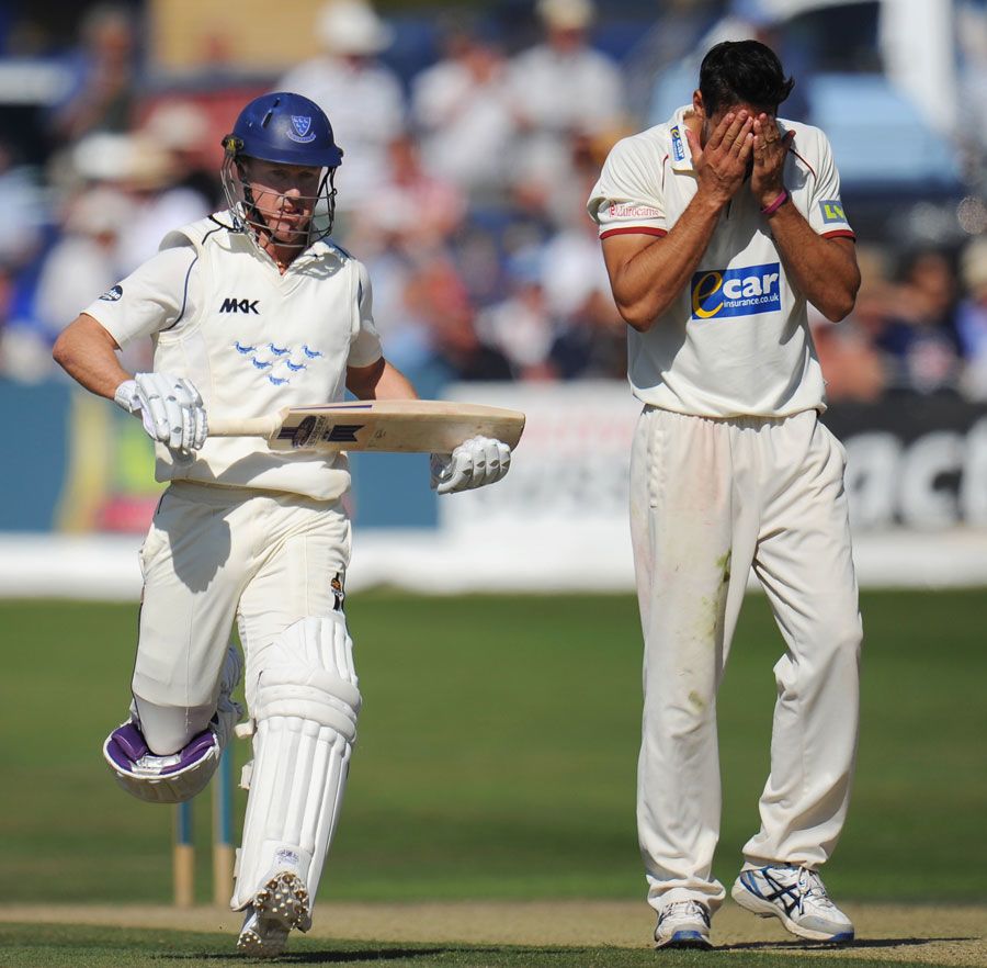 Sajid Mahmood holds his head in his hands as Murray Goodwin completes a run