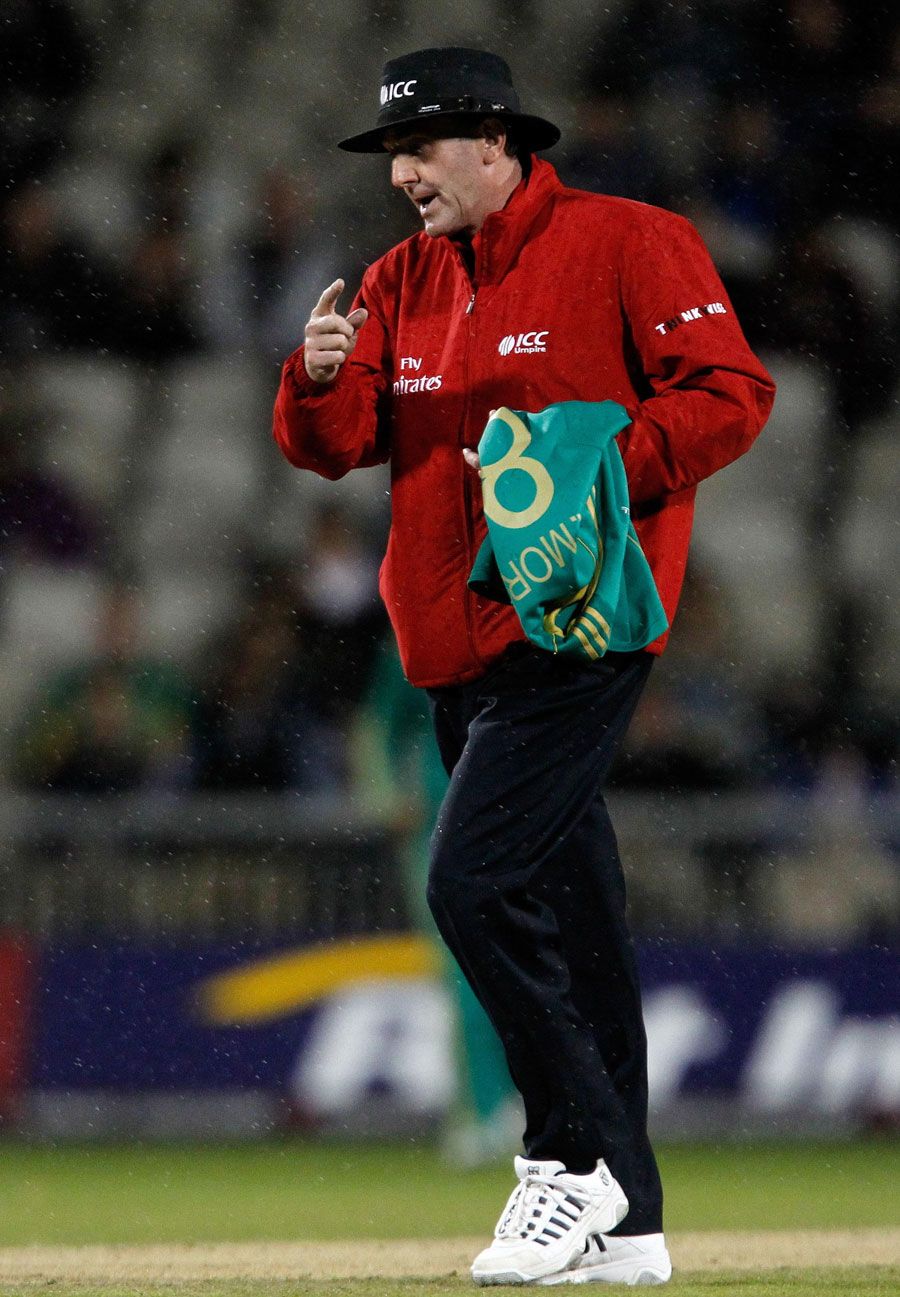 Umpire Rob Bailey gives the final signal to leave the field for good