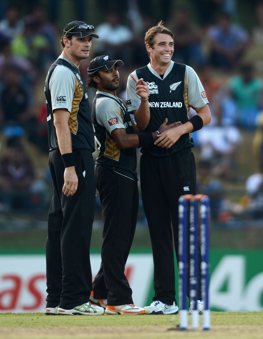 Tim Southee celebrates a wicket with Ronnie Hira and Kyle Mills