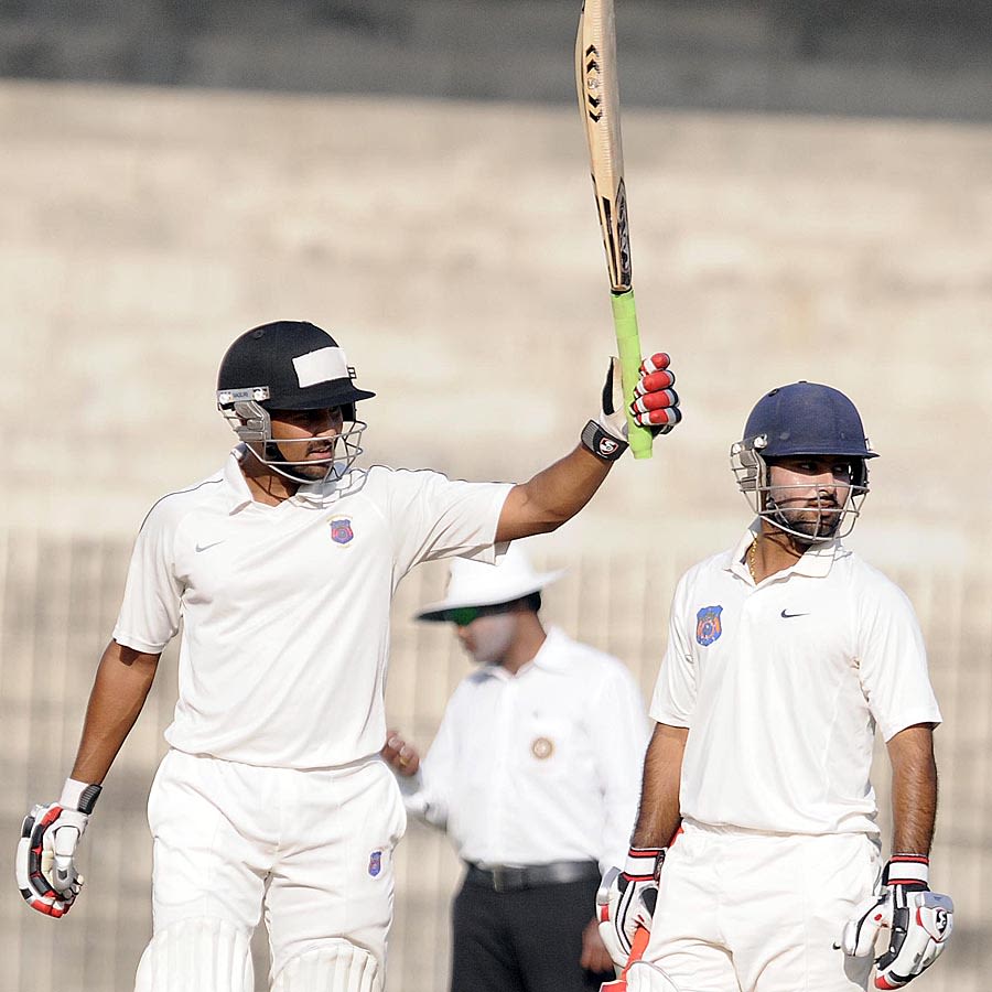 Shrikant Mundhe raises his bat after scoring a half-century