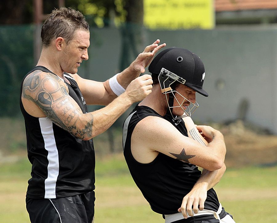 Brendon McCullum adjusts Rob Nicol's helmet at practice