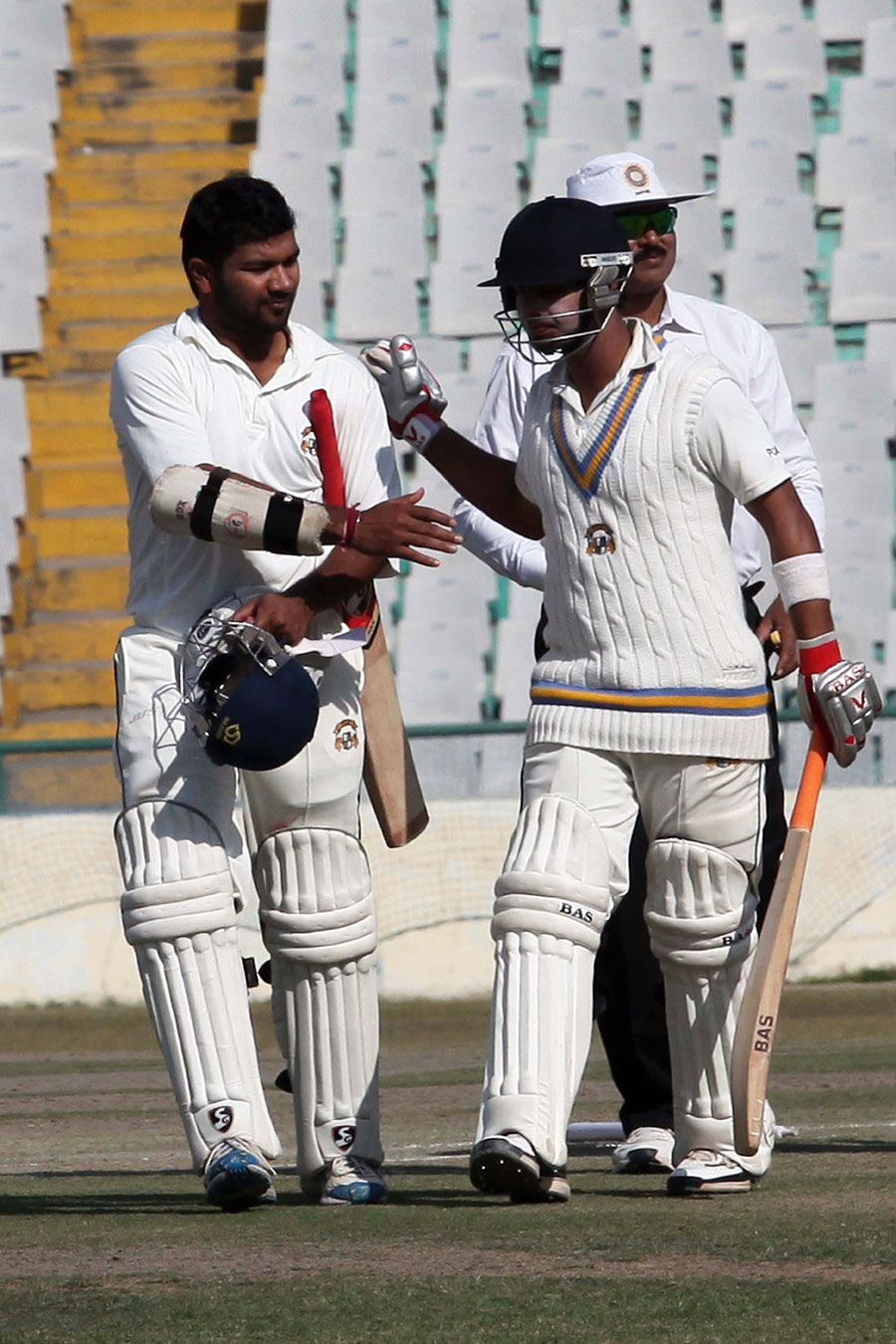 Karan Goel and Mandeep Singh walk off after securing victory