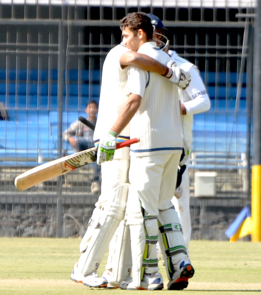Rajat Paliwal being congratulated after completing his hundred